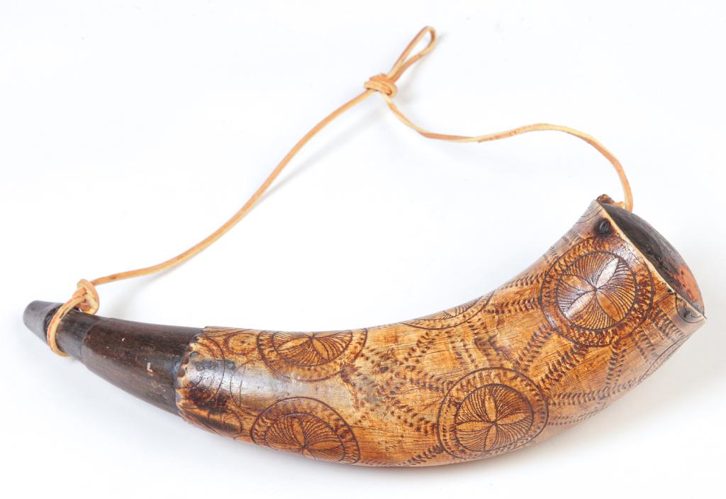 AMERICAN ENGRAVED POWDER HORN.: Nineteenth century. Chip carved detail with compass star designs and "Walter Stevens". Engraved designs are probably later additions. 12.5"l.