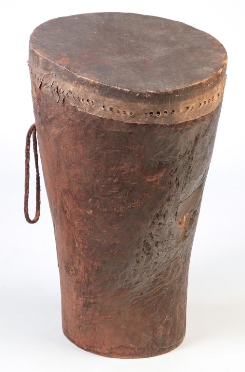 AFRICAN DRUM.: Twentieth century. Skin drumhead pegged to hollow trunk base. 32"h.18.5"w. 15.5"d.