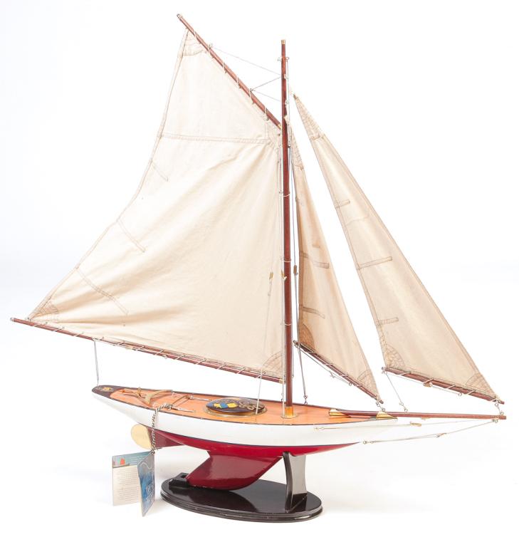 AMERICAN POND SAILER.: Late 20th century. Made by "Authentic Models, Eugene, Oregon". Single masted cutter with RMY 1923 with flags painted on hatch cover. 35"h. 38"l. 6"w.