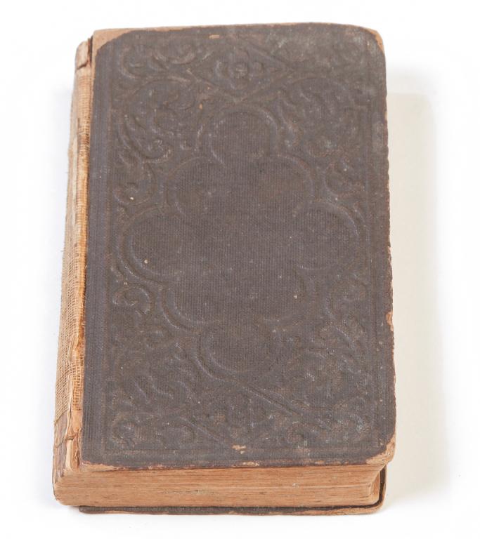 CIVIL WAR ERA BIBLE WITH INSCRIPTION.: Small New Testament Bible published in 1862. Inscribed, "Given to Amos P. Harland in 1862 by his father sent from Indianapolis before he left for war...". Foxing, damaged spine.