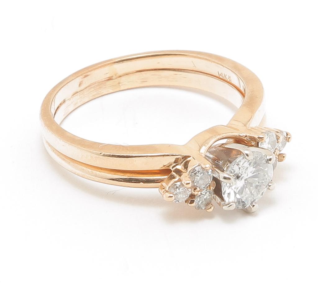 14 KARAT GOLD AND DIAMOND WEDDING RING SET.: American, contemporary. Stamped 14K yellow gold engagement ring with wedding band wrap. Round brilliant diamond solitaire approx. .70ct., I1clarity, H/I color. Six small round brilliant diamonds, esti