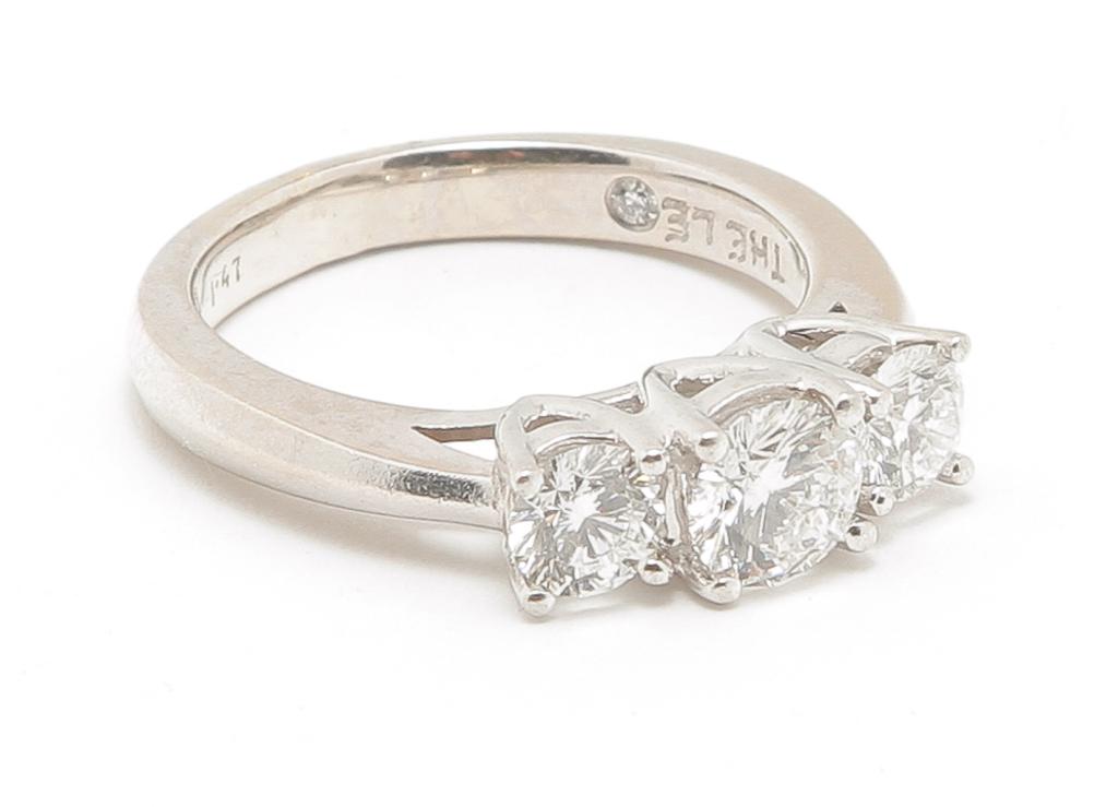 14K WHITE GOLD & PLATINUM 3-STONE DIAMOND RING.: American, late 20th century. 14K white gold and platinum 3 stone diamond ring featuring a .70ct round center diamond flanked by a round diamond on each side. Side diamonds approx. .30 and .31ct. Clari