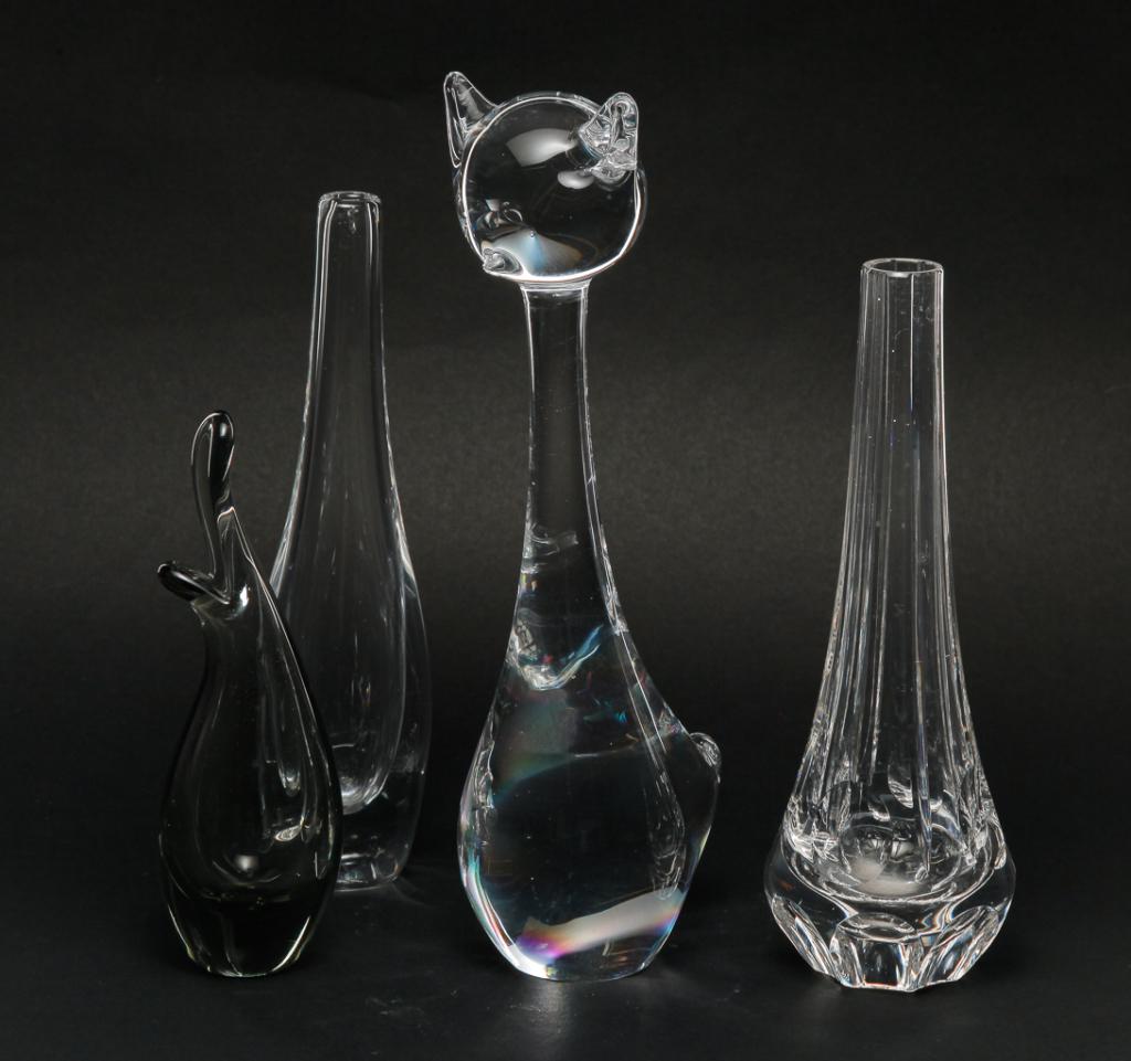 FOUR PIECES OF EUROPEAN GLASS.: Late 20th century. Signed Swedish "Orrefors" bud vase, 8"h., unsigned cut bud vase, 8"h., grey smoked bud vase with illegible signature numbered "15272", 6.5"h. and a long necked cat, 10"h.