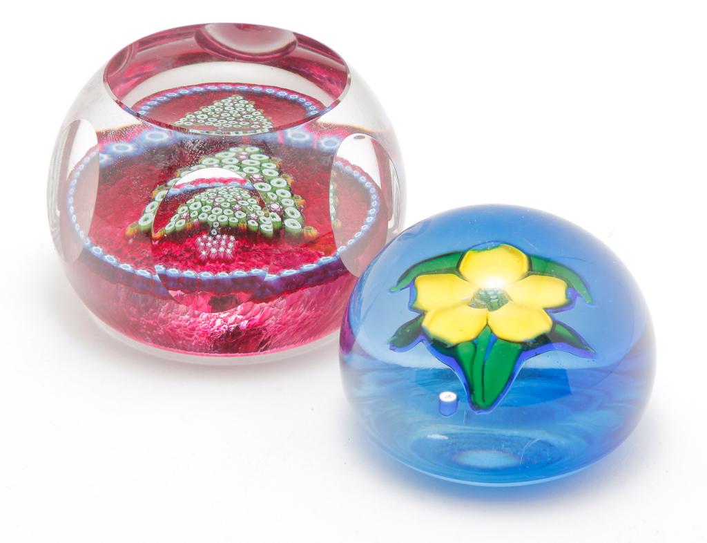 TWO UNITED KINGDOM PAPERWEIGHTS.: Fourth quarter 20th century. Whitefriars Christmas weight with table cut top and fluted sides, red interior with millefleur canes border and Christmas tree center. 1982 date canes on bottom, limited e
