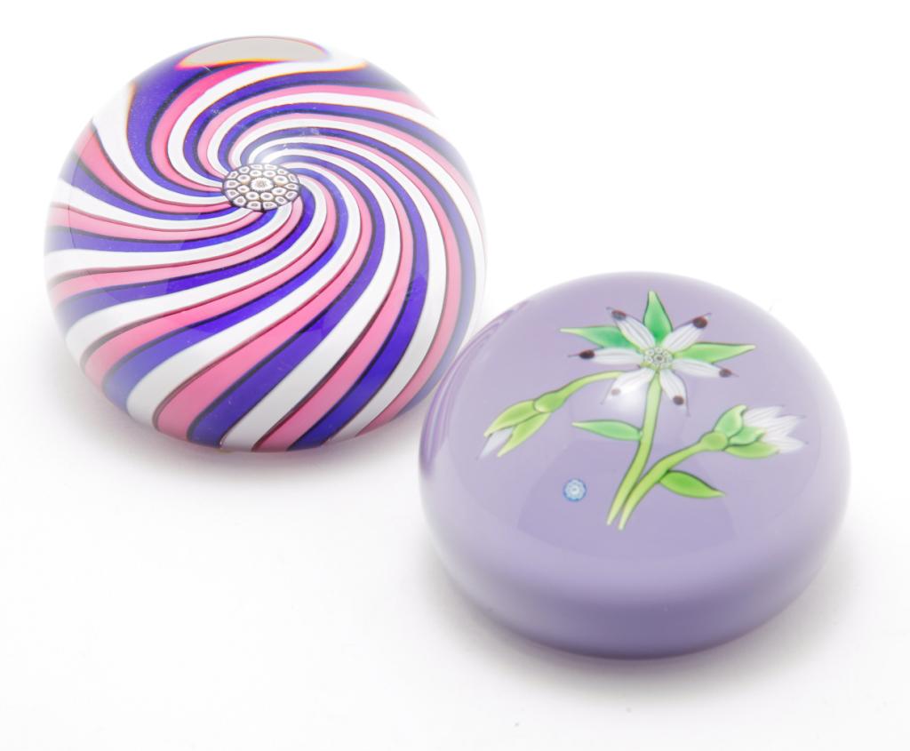 TWO SCOTTISH PERTHSHIRE PAPERWEIGHTS.: Fourth quarter 20th century. Red, white and blue swirl with millefleur center, 1980 date cane and "P" on bottom with original label. 3"d. And a lavendar interior with flowers and "P" cane. 2.75"d.