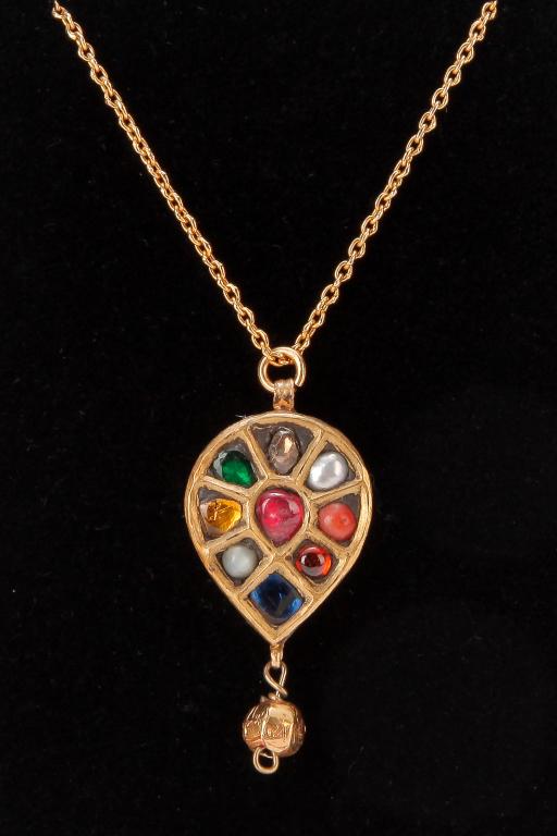 MUGHAL GEM-SET YELLOW GOLD PENDANT.: Indian, mid-late 20th century. 18K yellow gold, teardrop - shaped pendant (x-ray metal tested). Center pear-shaped ruby surrounded by multi-color gems including pearls, polki diamond slice, emerald, c
