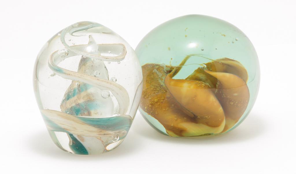TWO AMERICAN STUDIO GLASS PAPERWEIGHTS.: Second half 20th century. Signed and dated. Kent Ipsen with beige amorphous center cased in aqua, 1974. 4"d. And Daniel Edler with center shell shape and swirl in yellow, white and turquoise cased in 