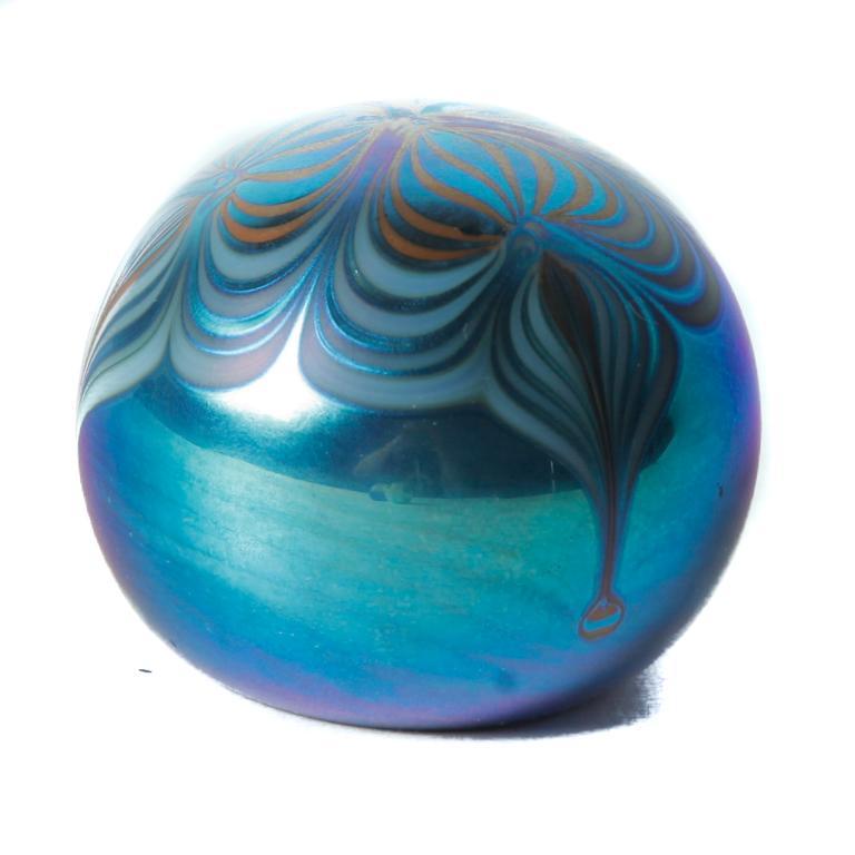SIGNED LOETZ-STYLE IRIDIZED PAPERWEIGHT.: Late 20th century. White case in blue with pulled feather design. Signed on bottom, 2"h. 2.75"dia.