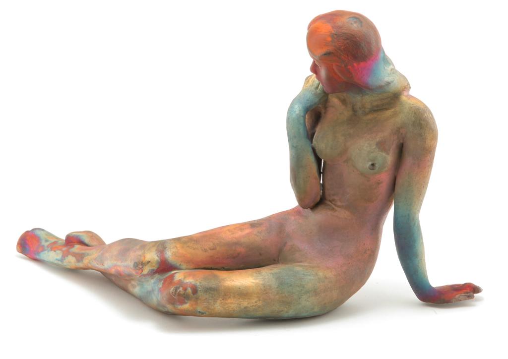 FEMALE NUDE BY GEORGE TUDZAROV.: American 1944-2000. Clay with raku glaze, signed and dated "Zaro '93" on bottom. Reclining figure. 10.25"h. 16.5"w. 6"d. Includes a signed brochure and one of Tudzarov's business cards.