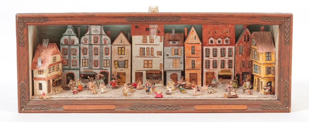 AMERICAN DIORAMA OF PARIS STREET.: Mid 20th century. Executed by Irma Park. Seventeenth century scene wtih three and four story buildings and people in the street performing daily activities. 8.75"h. 23.75"w. 7"d.