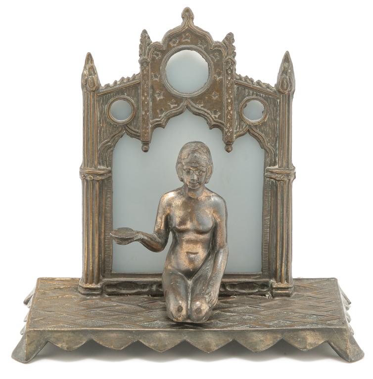 AMERICAN FIGURAL LAMP.: Second quarter 20th century. Cast white metal with brass finish. Nude femil kneeling figure holding a round salver against a gothic arched background. 8.5"h.