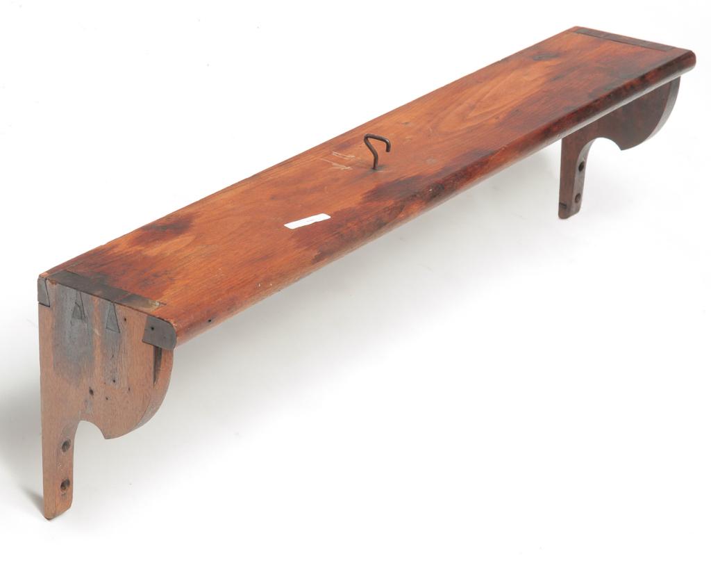 ZOAR SHELF.: Ohio, mid 19th century, walnut. Dovetailed with old dark stain. Hook inserted on one side. Cleaned with traces of white paint. 9"h. 34"l. 5.75"d. Ex Jack Adamson, (Ohio). Ex Don Whitemyer (Ohio).
