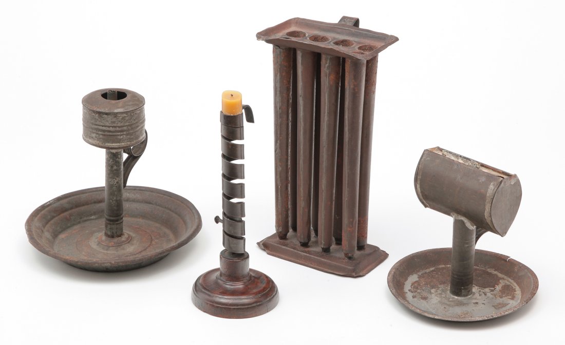 FOUR AMERICAN LIGHTING DEVICES.: First half 19th century. Wrought iron spiral candlestick on turned walnut base, 8.75"h., tin whale oil chamberstick, tin chamberstick with tear drop shaped font, 6.5"h. and an eight tube candlemold, 1