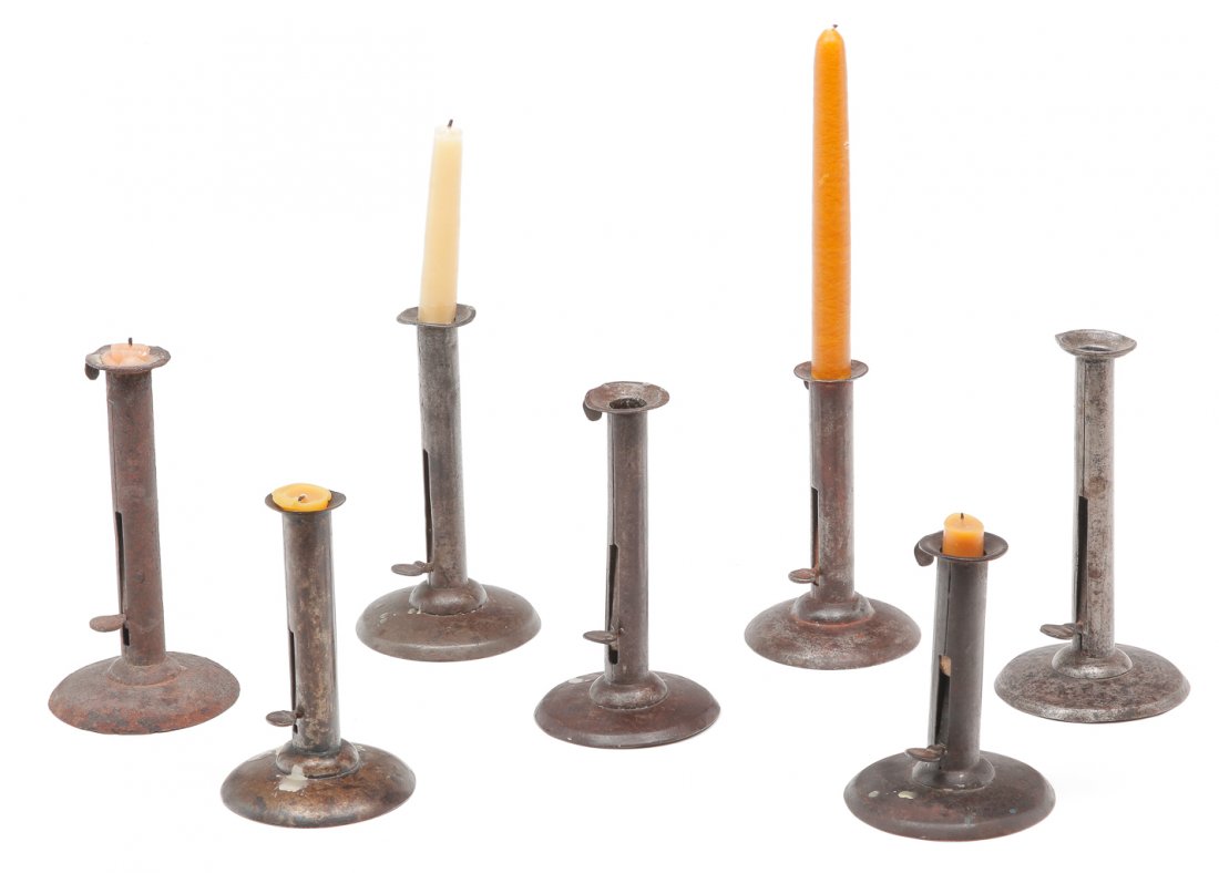 SEVEN ENGLISH HOGSCRAPER CANDLESTICKS. (1 of 2)