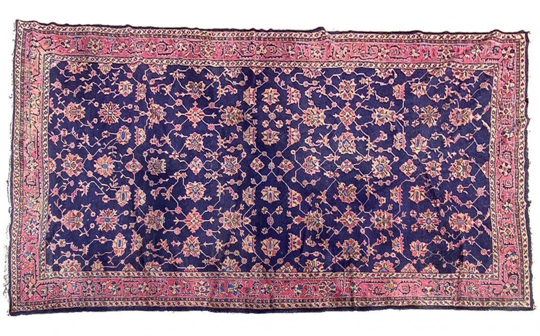 PALATIAL ANATOLIAN RUG.: Ca. 1920. Overall floral arabesque on indigo field with mauve border. 9'7" x 17'6".