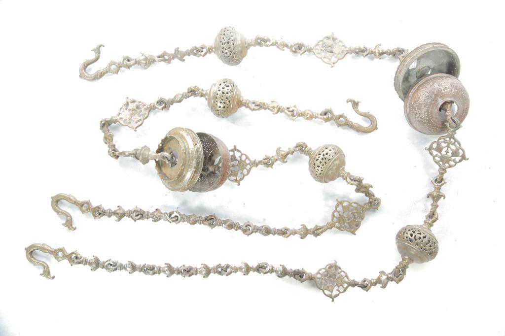 PAIR OF CAST BRASS HANGING CHAIN LAMPS.: India, late 19th century. Heavily cast with medallions, orbs, foliate links and hooks. 86"l.