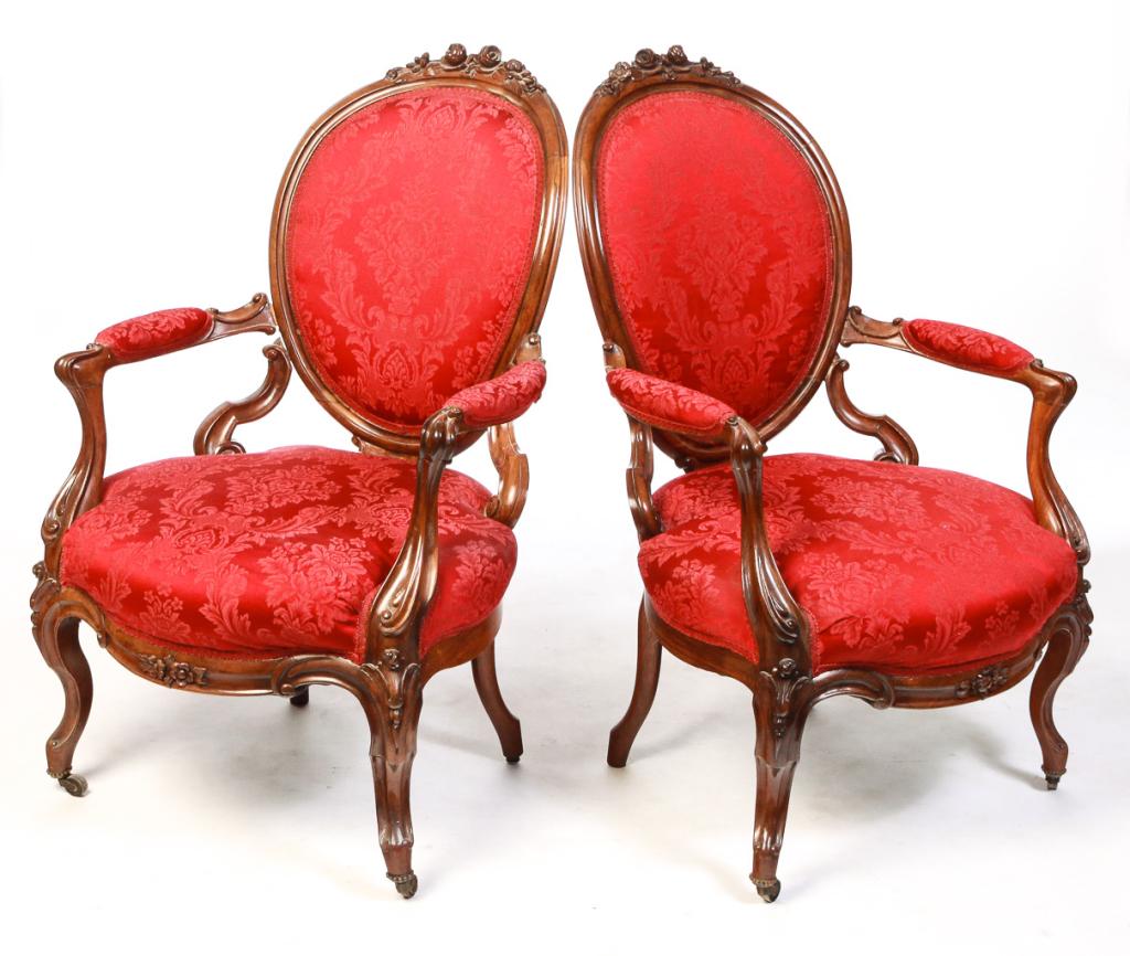 PAIR OF FRENCH LATE VICTORIAN ARMCHAIRS.: Late 19th century, walnut. Floral carving and knuckle arms. Red damask reupholstery. Frames impressed â€œMade in France”. Repairs. 16” seat. 39”h.