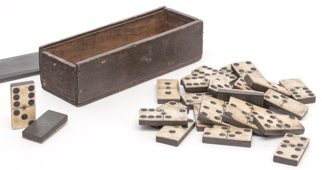 AMERICAN DOMINOS.: Second half-19th century. Twenty six bone and ebony dominos in a nailed, slide lid box. Some loss and replaced nails. Box 2”h. 7”l.