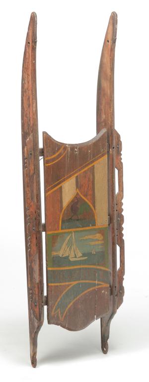AMERICAN DECORATED SLED.: Fourth quarter 19th century, mixed woods with iron runners. Unusual cut out hand holds on sides and seat with yellow pinstriping, rooster, sailboats and blue ribbon with "Volunteer". Wear, repairs and