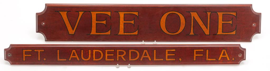 TWO AMERICAN SAILBOAT NAME BOARDS.: Fourth quarter 20th century, mahogany. Cut corners, routed edges. Lettered "VEE ONE", 7.25"h. 42"w. and a stern port of registry board "Ft. Lauderdale, Fla", 3.75"h. 42"w.