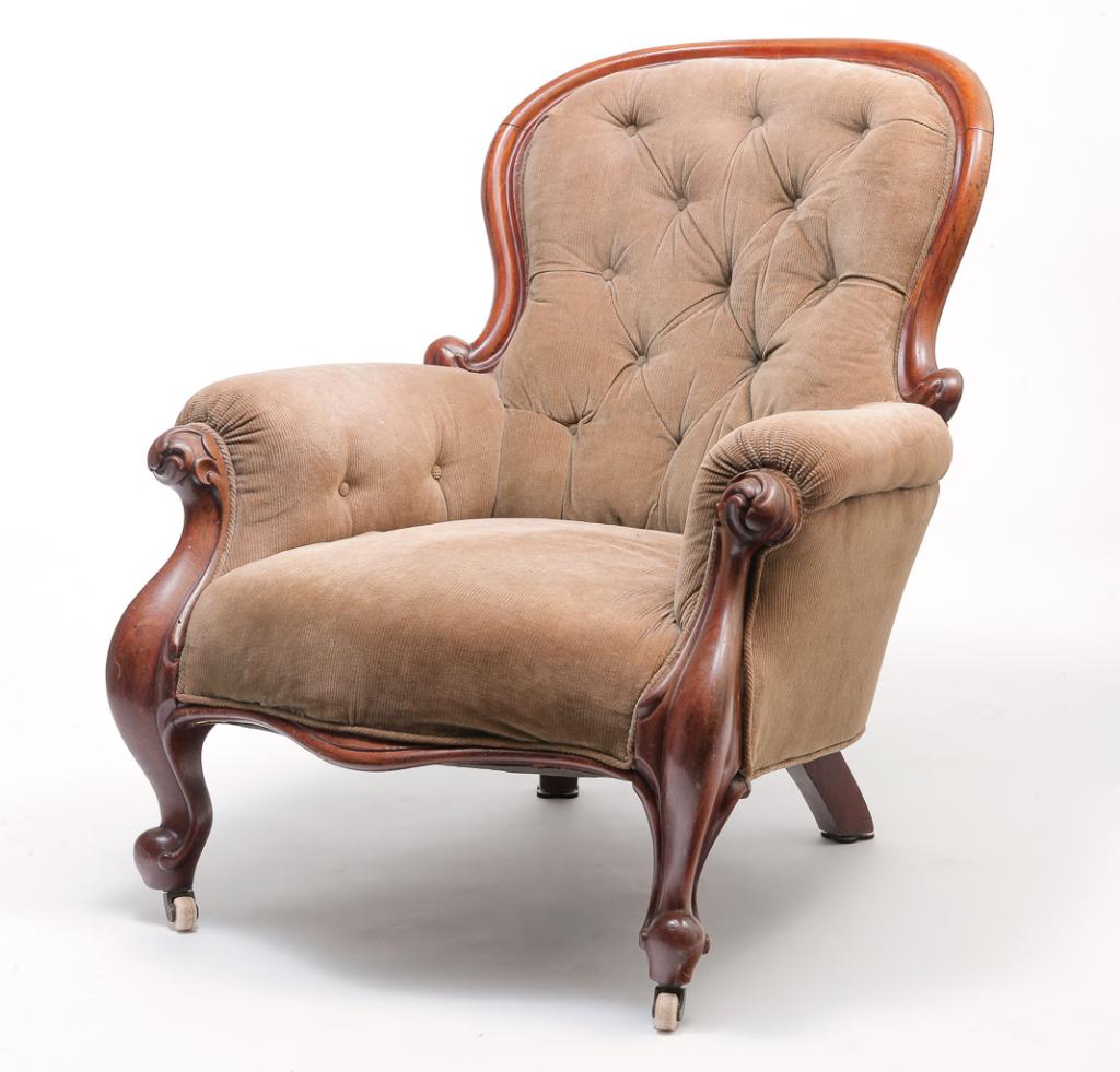 EUROPEAN VICTORIAN ARMCHAIR.: Third quarter 19th century, European walnut. Carved frame, porcelain casters and corduroy upholstery. 16" seat, 35"h.