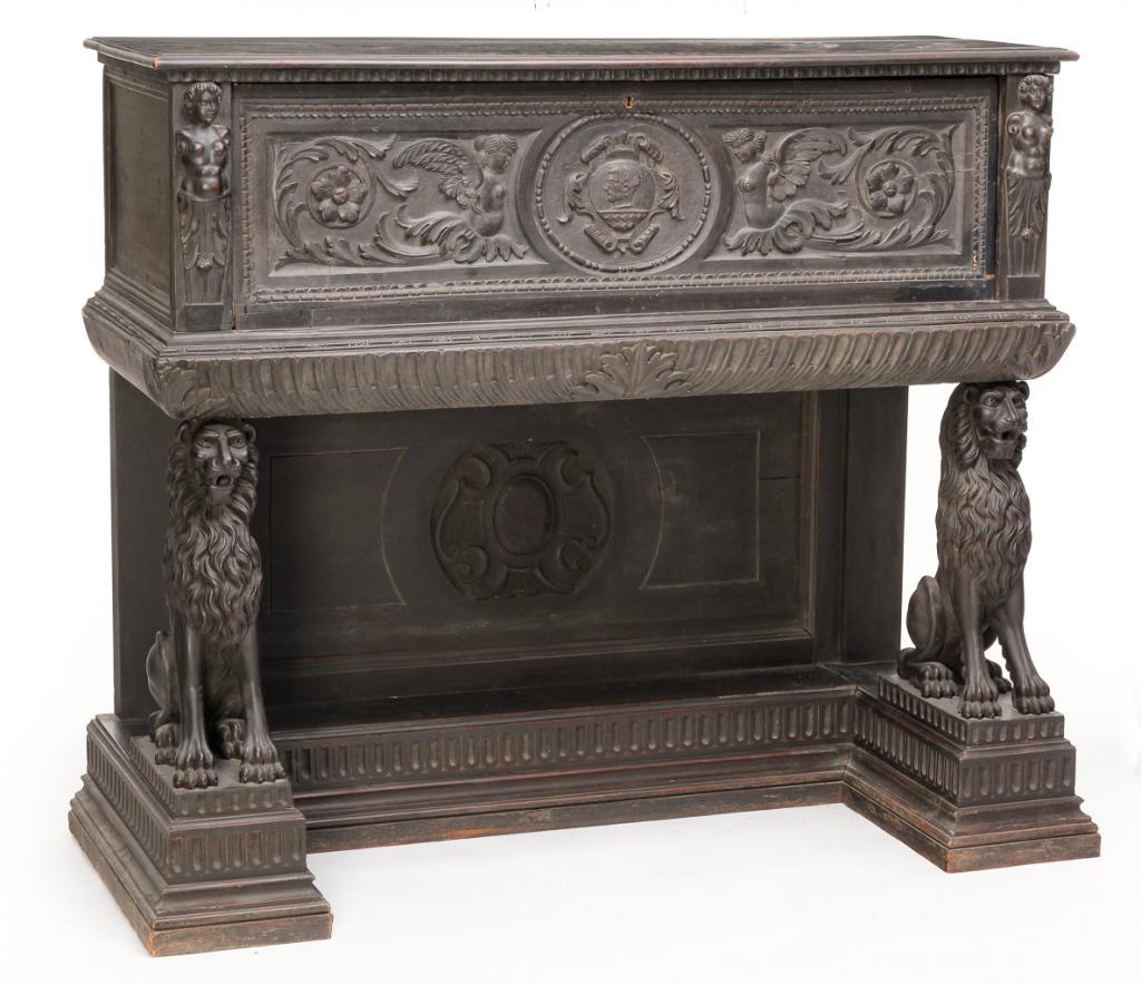 EUROPEAN LIVERY CABINET.: Nineteenth century, mixed woods including oak. Incorporates some 17th century elements with rosehead nails. Two pieces. Case with carved drop front featuring angels, foliage and center medallion of a 