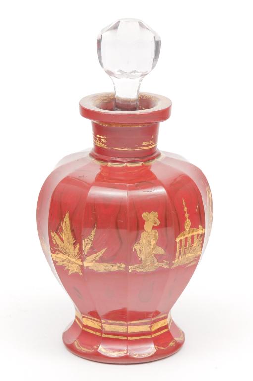 BOHEMIAN LITHYALIN COLOGNE.: Mid 19th century. Panel cut rust red glass with darker striations resembling stone. Gold Asian scene decoration and trim. A few small flakes on lip and replaced stopper. 4"h .plus stopper.