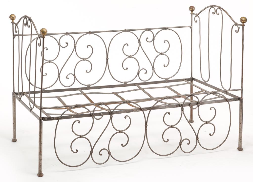 AMERICAN STEEL DAY BED.: Ca. 1900, polished steel. Converted from a child's bed with scrolled tubular steel decoration and brass post knobs. 36.5"h. 56.5"w. 24"d.