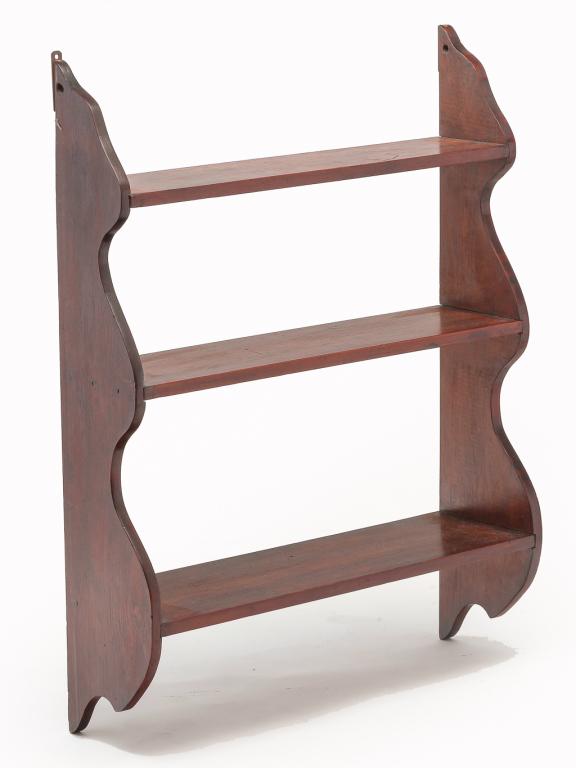 AMERICAN SET OF HANGING SHELVES.: Second half 19th century, pine. Shaped sides with three graduated shelves. Refinished with dark reddish stain. 34"h. 25.5"w. 7.5"d.