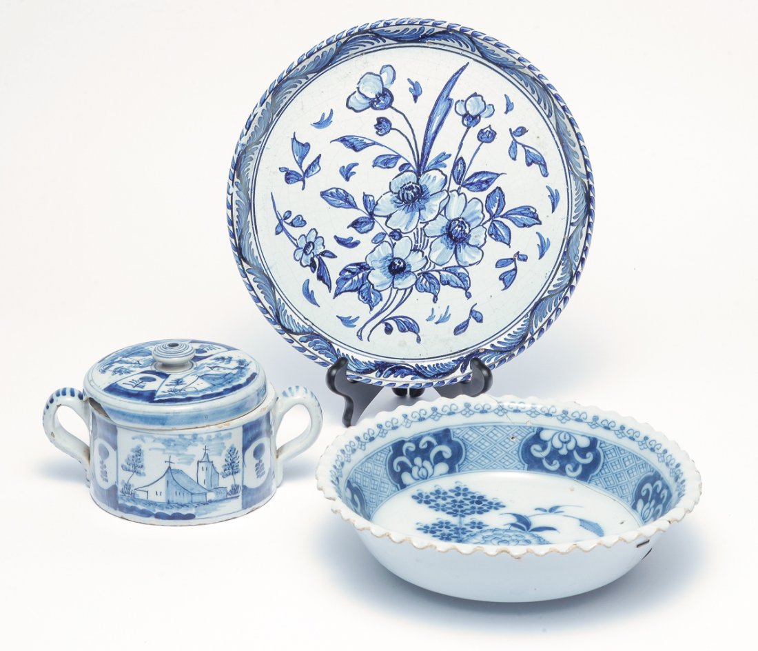 THREE PIECES OF DELFT.: European, 18th-19th century. Bowl with floral decoration and scalloped edge. Stapled repair, chips. Ex Martyn Edgell. 3"h. 10.5"d., covered dish with double handles and decorated with buildings. Edge 