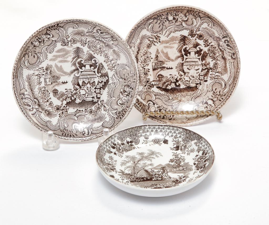 THREE ENGLISH STAFFORDSHIRE SAUCERS.: Second half-19th century. Brown transfers. Bee skep. Tiny ring flake. 4"d. And two "Mycenae" with urn by Adderley. Light stains. 4.5"d.