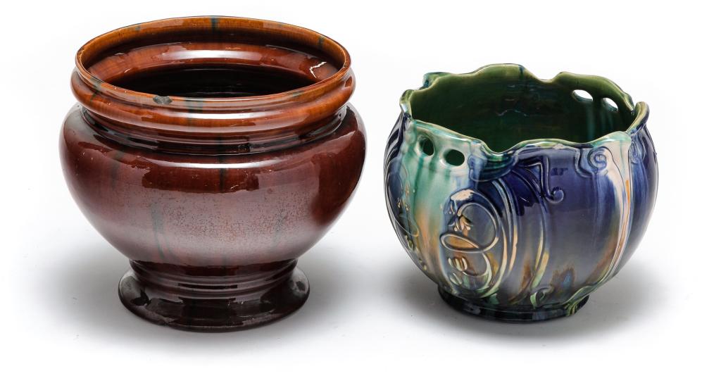 TWO OHIO ART POTTERY JARDINIERES.: Ca. 1900. Mottled green, blue and beige high glaze with embossed floral pattern, 9"h. 11"d. And mottled brown high glaze. Rim chip. 10.5"h. 13"d.