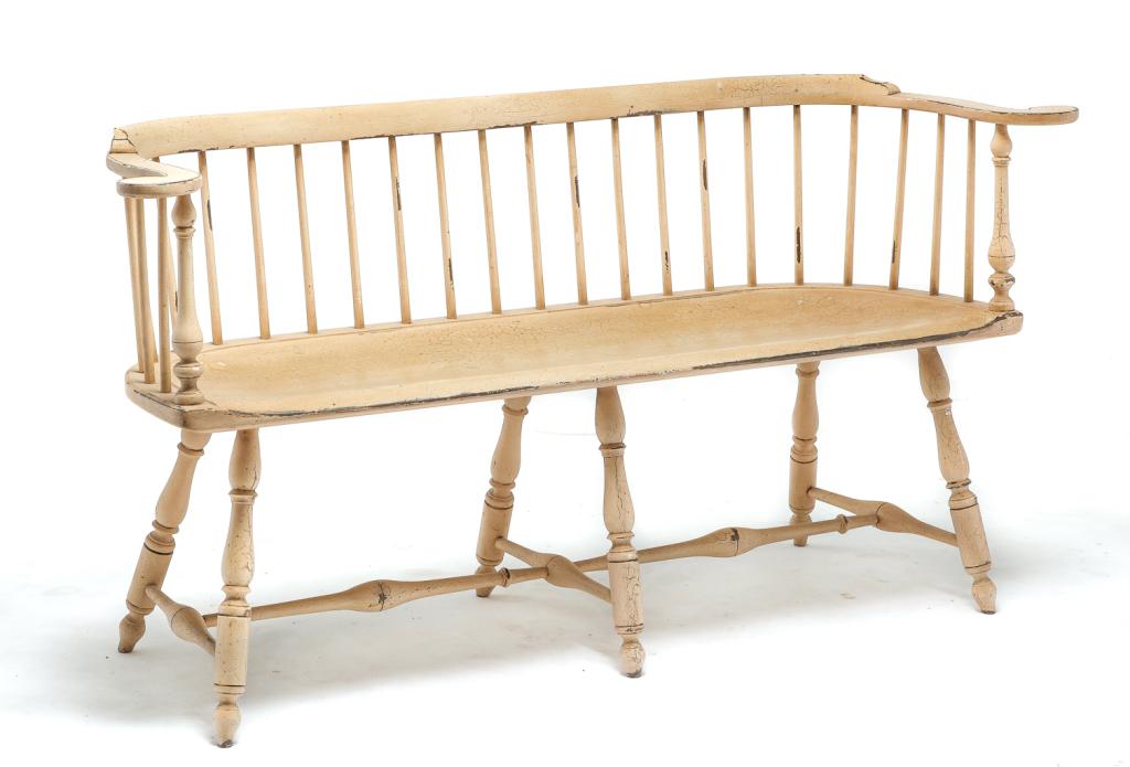 D.R. DIMES WINDSOR STYLE SETTLE BENCH.: American, 4th quarter 20th century, mixed woods. Low spindle back, rolled arms, boldly turned stiles, legs and stretchers. Distressed "antique white" paint. Incised label under seat. 17.5" seat. 30"h.