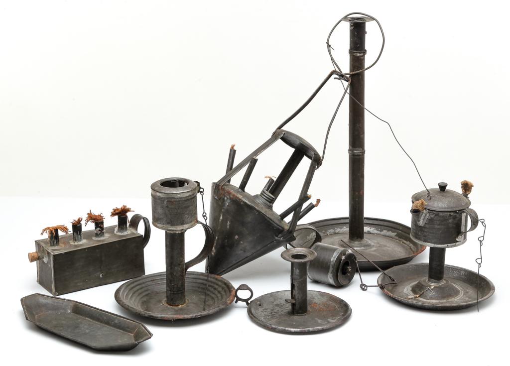 NINE PIECES OF AMERICAN TIN LIGHTING.: Mid 19th century. Five burner whale oil hanging lamp with conical font, 18.5"h. Rectangular four burner whale oil hanging lamp with handle, 4"h. 7.25"w. 3.75"d. Whale oil lamp on saucer base, handled 