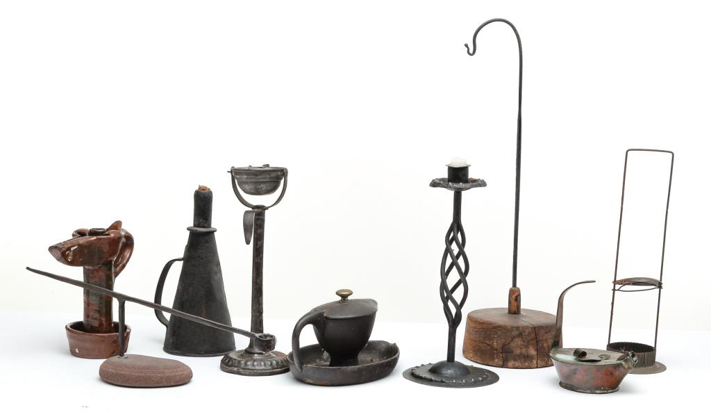 NINE PIECES OF LIGHTING.: American and European, 19th-20th century. Cast iron grease lamp with saucer base, 5"h., redware grease lamp, 7.75"h. brass betty lamp, 5.5"h., gimbal mount grease lamp, 11.25"h., conical shaped torch
