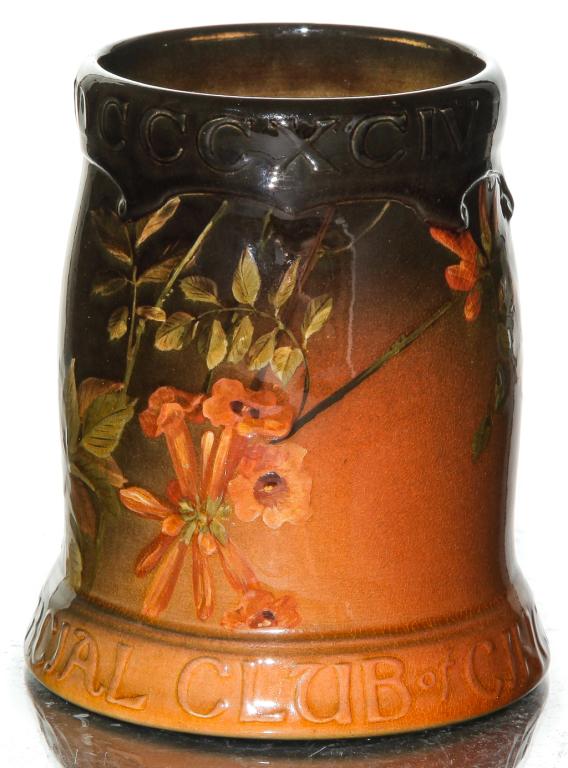 ROOKWOOD STANDARD GLAZE STEIN BY DANIEL COOK.: Dated 1895. Shape number 783 with trumpet creepers decoration, made for the Cincinnati Commercial Club. Missing pewter hinged lid, small hairline at edge of table ring. 5.25"h.