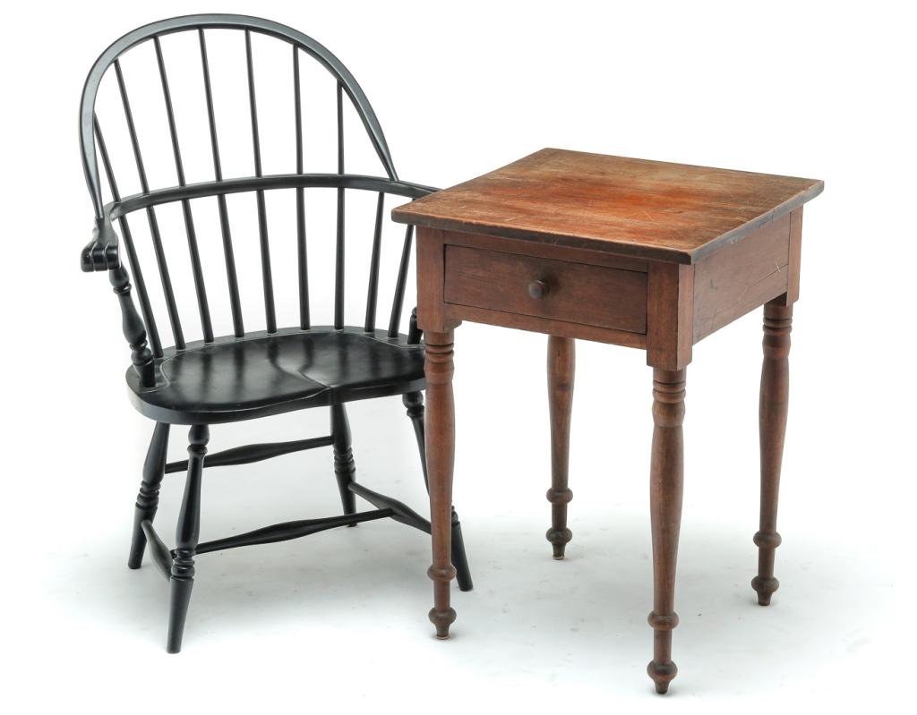 TWO PIECES OF AMERICAN FURNITURE.: Second quarter 19th century. Sheraton work table, cherry with poplar secondary. Dovetailed drawer and turned legs. Finish wear and age splits. 28.75"h. 20"w. 19.5"d. And a mid 20th century sackback Wi