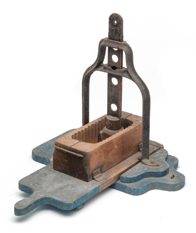AMERICAN CAST IRON AND WOODEN PRESS.: Patented 1867. Old worn blue paint, mold mounted on sliding handled platform with cast iron frame and handled temper, 15.5"h.