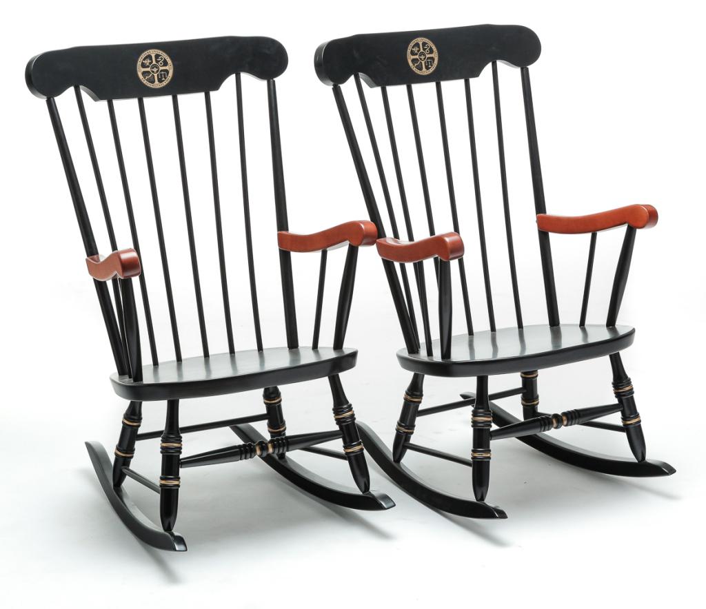 PAIR OF OHIO NORTHERN UNIVERSITY ROCKING CHAIRS.: Late 20th century, maple. Black paint, natural arms and gold highlights. Crest with Ohio Northern seal and Latin motto, spindle backs, rolled arms and turned legs and stretchers. 16" seat, 40"h.