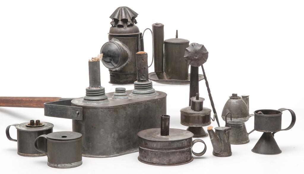 TEN PIECES OF AMERICAN TIN LIGHTING.: Nineteenth century. Double burner campaign torch with wooden handle, 7.5"h., tinder box candle holder with flint and steel, 3.5"h., miner's teapot shaped lamp, 3.25"h, betty lamp with twisted iron han