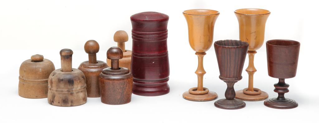 TEN PIECES OF WOODENWARE.: American, 19th-20th century. Four miniature treenware goblets and a container, 3" to 4.25"h. And five miniature cased butter prints. Average 2.5"h.