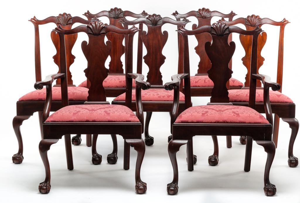 EIGHT HENKEL-HARRIS CHIPPENDALE STYLE CHAIRS.: Second half 20th century, mahogany. Crests with carved ears and center shells, vase backs, cabriole legs with ball and claw feet and slip seats with red brocade upholstery. Two arms and six sides, 18"