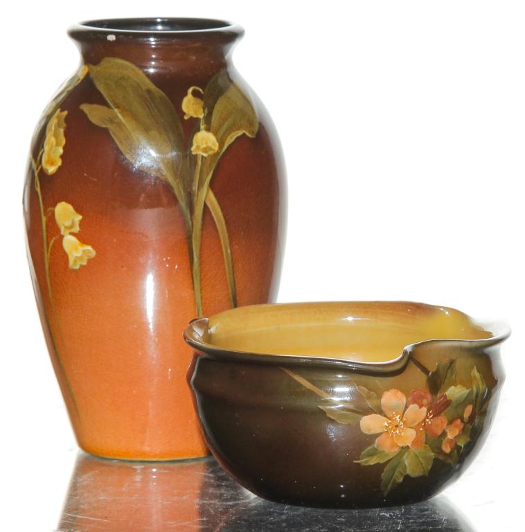 TWO PIECES OF ROOKWOOD STANDARD GLAZE ART POTTERY.: One 1891 Anna Valentien ash receiver, shape number 582 with poppies decoration, signed on bottom, professional repair, 1.75"h. One 1897 Rose Fechheimer bud vase, shape number 568E with lily-of-the-val