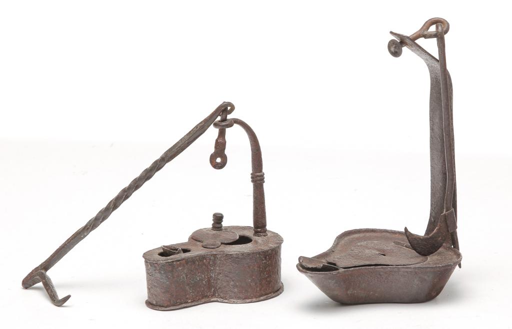 TWO AMERICAN BETTY LAMPS.: First half 19th century. Hand made of sheet metal and steel with twisted forged iron hanger. 4"h. and tine with wire and tin hinge. Missing lid finial. 6"h.