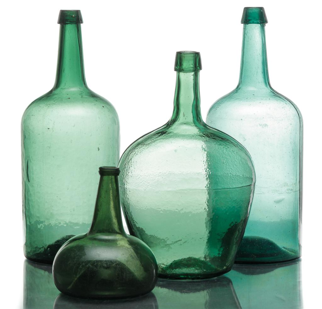 FOUR EUROPEAN GREEN BLOWN BOTTLES.: Mid 19th century. Two are straight sided demijohns with blob tops and iron pontils. 15.5"h, and a wide shouldered small demijohn with blob type top and broken pontil, 13.5"h. Together with an onion sh