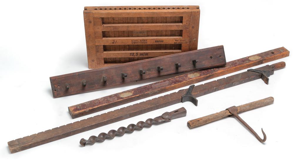 SIX WOOD AND IRON PIECES.: German "Karl Hart" cigar mold, 2.5"h. 22"w. 13"d. And five American pieces. Forged hook with wooden handle, 10"h. 18"w., forged and cast "Fulton Tool Wks" auger bit, 2"h., a wood and cast iron bar cla