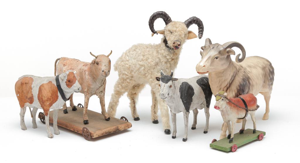 SIX COW AND RAM TOYS.: Mostly German, early 20th century. Four cows. Three are papier mÃ¢chÃ© with original paint, one is a pull toy. 4.25" to 5.5"h. And a hide covered pull toy pipsqueak with working voice box. 6.75"h.
