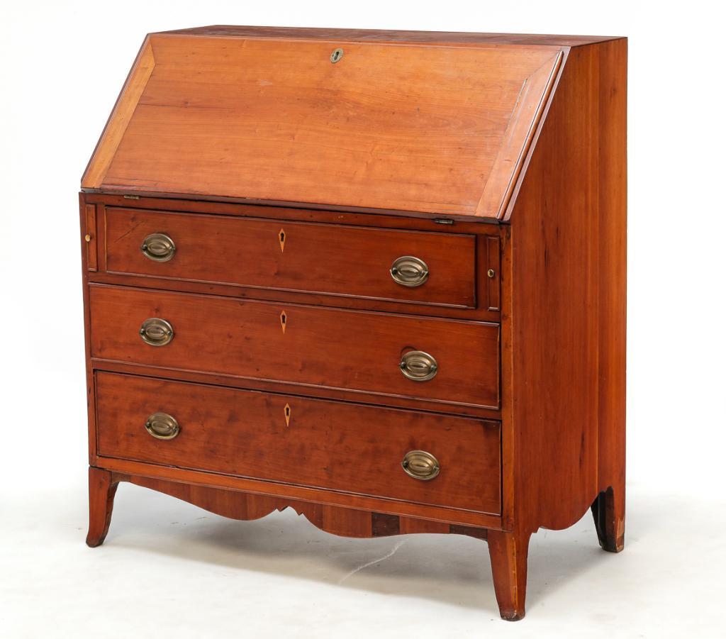 AMERICAN HEPPLEWHITE SLANT FRONT DESK.: First quarter 19th century, cherry and pine secondary. Solid ends, French feet and three dovetailed drawers with applied beaded edges. Fitted interior with pigeon holed and dovetailed drawers with tig