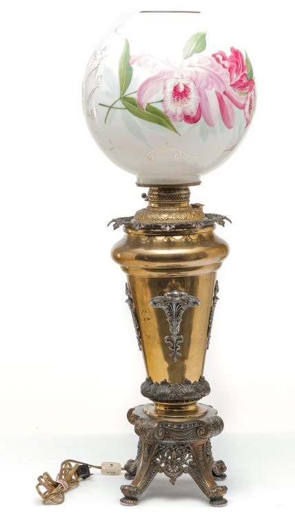 AMERICAN VICTORIAN BANQUET LAMP.: Fourth quarter - 19th century. Milk glass ball shade with floral enameled decoration and brass and white metal base with pressed and cast detail including harps and eagles. 21"h plus 11" shade with 4"