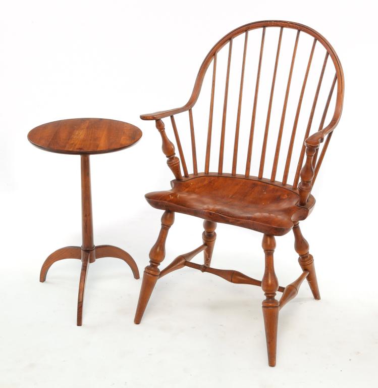 TWO PIECES OF PERIOD STYLE FURNITURE.: Second half 20th century. A "Pennsylvania House" pine candle stand with round top, plainly turned column and scimitar legs. 24"h. 15"d. And a Yugoslavian continuous arm Windsor, spindle back, boldly t
